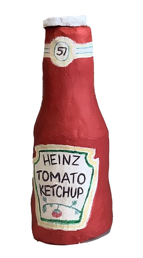 A handcrafted clay bottle designed to resemble a Heinz tomato ketchup bottle, featuring a red body, a white cap, and a hand-painted label with 'HEINZ TOMATO KETCHUP' text.