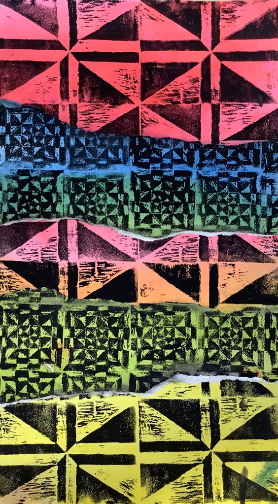 A colorful print featuring a geometric pattern with alternating shapes in red, blue, green, and black, showcasing a mix of triangles and squares.