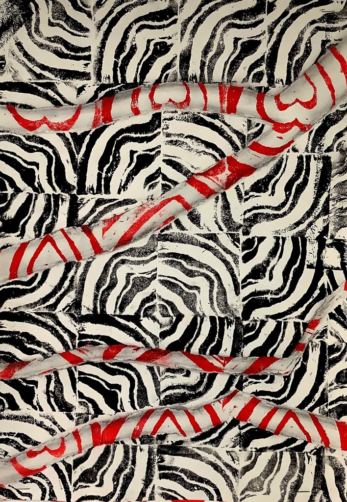 A printmaking project showcasing a pattern design featuring black and white zebra stripes with red accents, highlighting creativity and colour blending techniques.