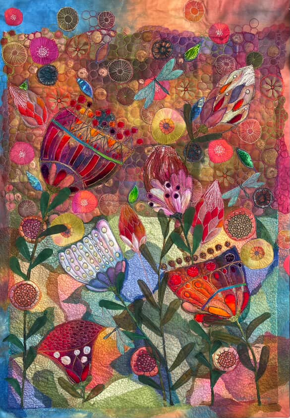 Michelle Mischkulnig - A vibrant textile artwork featuring colorful flowers, butterflies, and abstract shapes, showcasing intricate stitching and a rich blend of colors, inspired by nature.