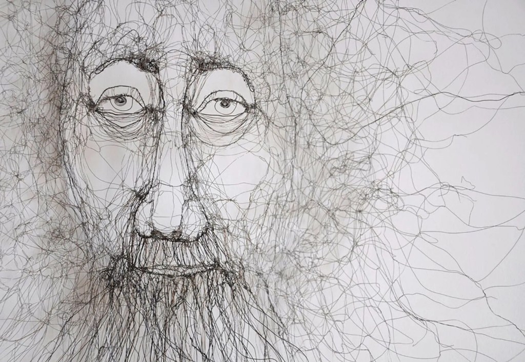 A detailed wire sculpture depicting a human face, showcasing intricate lines and textures that suggest depth and emotion.