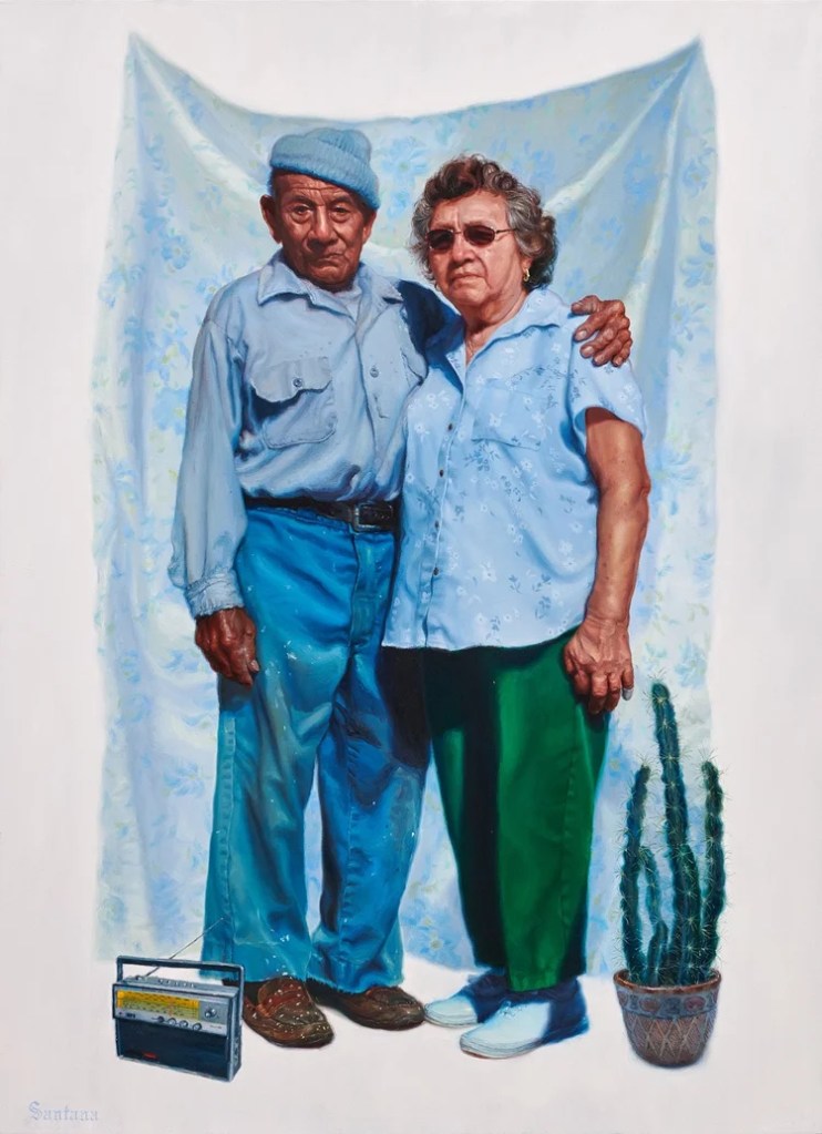 A couple standing together in front of a light blue floral backdrop. The man is wearing a blue cap and a blue shirt, while the woman is in a light blue blouse. A small potted cactus is beside them, and an old radio is on the ground. Vincent Valdez Painting