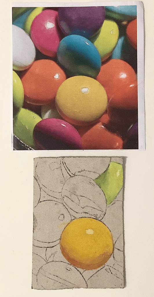 A colorful photograph of various candies in vibrant shades, displayed above a monoprinted oil pastel piece featuring similar round sweets, with emphasis on a yellow sweet in the foreground.